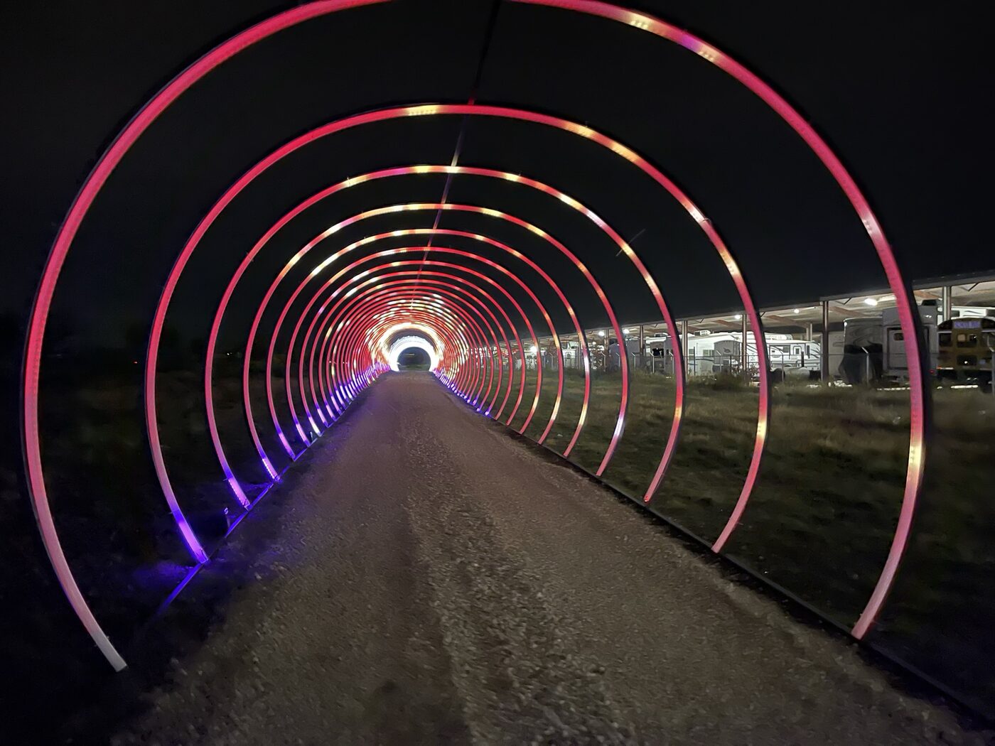 A long tunnel of concentric lit arches receding into the night