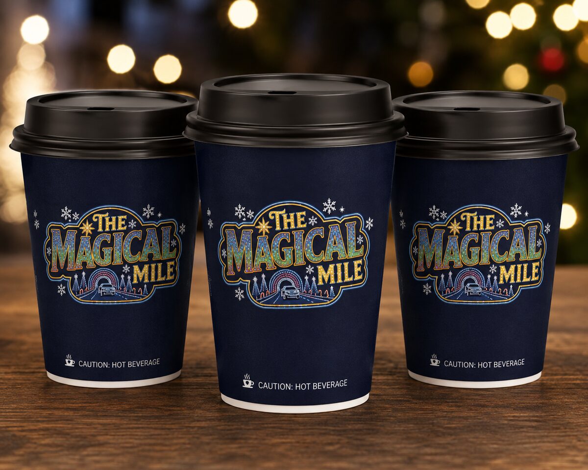 Three navy paper cups with black lids, each printed with The Magical Mile logo